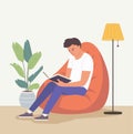 Young man is relaxing on comfortable beanbag chair and reading book. Vector flat illustration